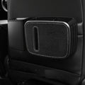 Car seat organizer with cup holder and storage space on a black car interior.